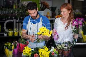Couple preparing flower bouquet