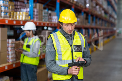 Warehouse worker using barcode scanner machine