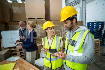 Warehouse workers and managers interacting with each other