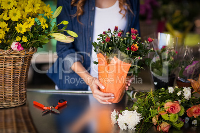 Female florist holding flower bouquet