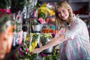 Happy female florist preparing a flower bouquet