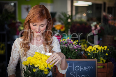 Female florist holding flower bouquet