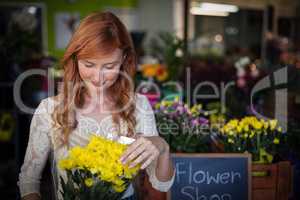 Female florist holding flower bouquet