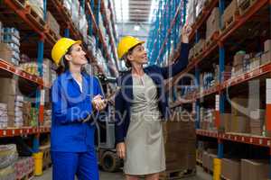 Warehouse manager and worker checking the inventory