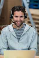 Man using laptop in warehouse