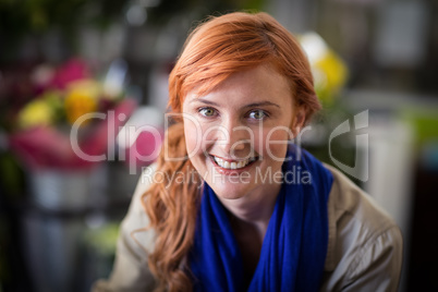Happy female florist in flower shop