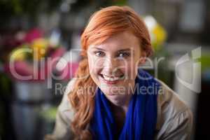 Happy female florist in flower shop