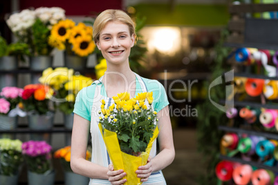 Female florist holding bouquet of flower