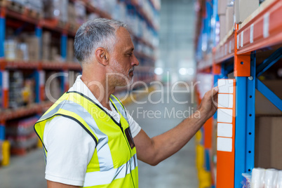 Warehouse worker looking in the shelf