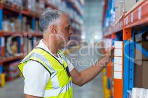 Warehouse worker looking in the shelf