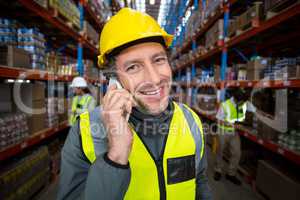 Warehouse worker talking on mobile phone