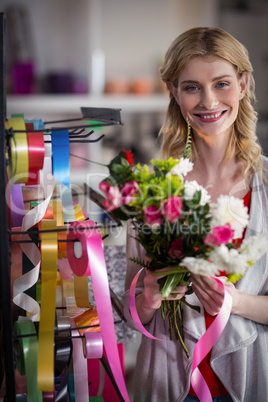 Female florist preparing a flower bouquet