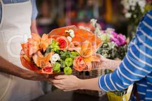 Florist giving bouquet of flower to customer