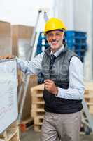 Portrait of warehouse worker standing near whiteboard