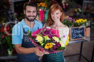 Portrait of couple holding flower bouquet
