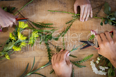 Hands of florist preparing flower bouquet