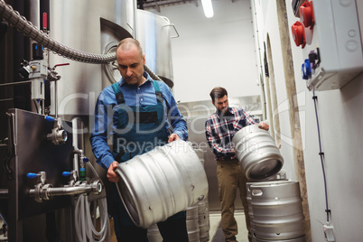 Owner and worker carrying kegs