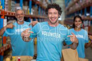 Portrait of volunteers pointing at t-shirt