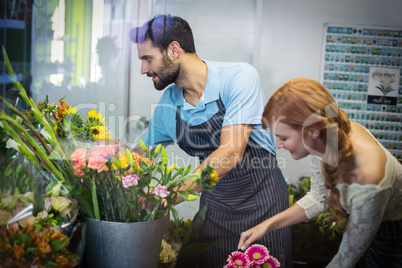Couple arranging flower bouquet