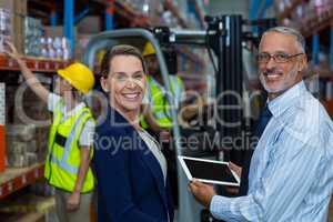 Portrait of warehouse manager and client smiling