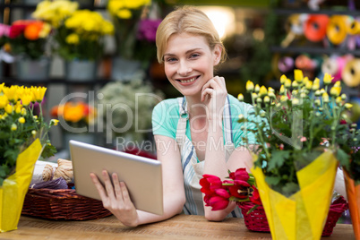 Female florist holding digital tablet