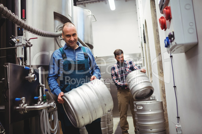 Worker and manufacturer carrying kegs