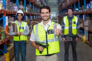 Warehouse worker showing thumbs up sign