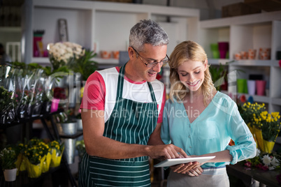 Florists using digital tablet in florist shop