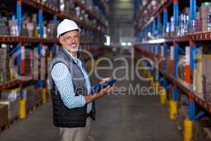 Portrait of warehouse worker checking the inventory