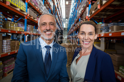 Portrait of warehouse manager and client smiling