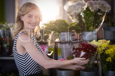 Female florist arranging flower bouquet