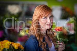 Female florist holding a rose flower