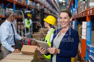 Warehouse manager holding digital tablet