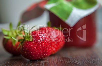 strawberry jam glass and berries homemade