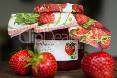 strawberry jam glass and berries homemade