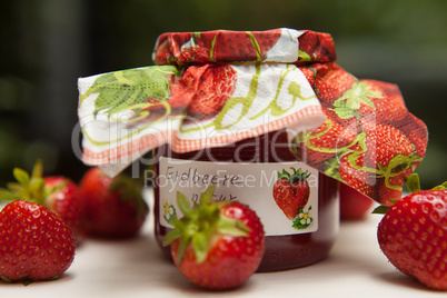 strawberry jam glass and berries homemade