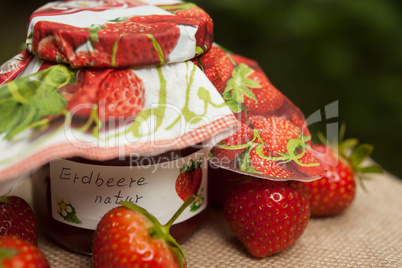 strawberry jam glass and berries homemade