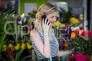 Female florist talking on mobile phone