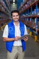 Warehouse worker holding digital tablet