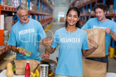 Portrait of volunteer pointing at t-shirt
