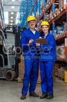 Warehouse workers standing together in warehouse