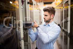 Technician removing server from rack mounted server