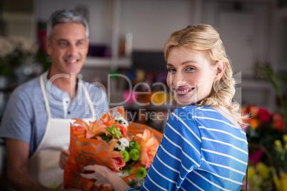 Florist giving bouquet of flower to customer