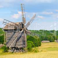 old wooden windmill in a field