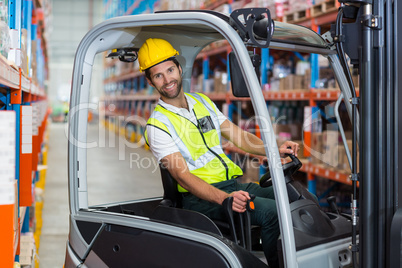 Male worker using forklift