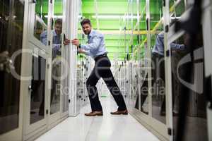 Technician adjusting server cabinet