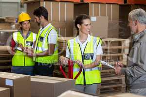 Warehouse manager and workers preparing a shipment