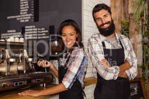 Waiter and waitress standing in kitchen