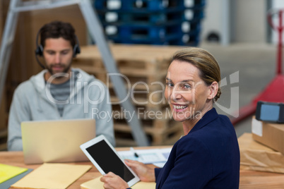 Portrait of warehouse manager using digital tablet