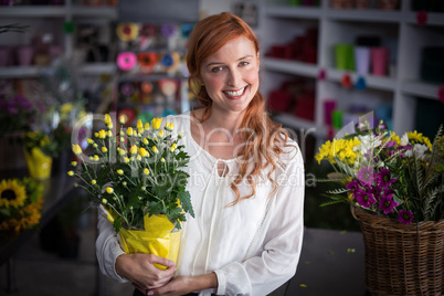 Female florist holding flower bouquet